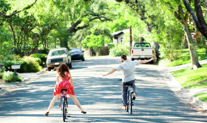 Couple Riding Bikes Around Neigborhood